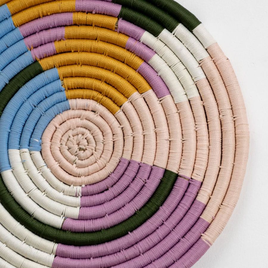 Handwoven round wall basket in multicolor pastel tones showing 40 cm diameter suitable for statement interior wall decor placement.