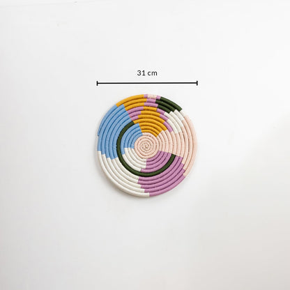 Cotton woven wall plate in pastel blue pink mustard green and cream shades shown on a white background with 31 cm measurement for accurate wall decor sizing.