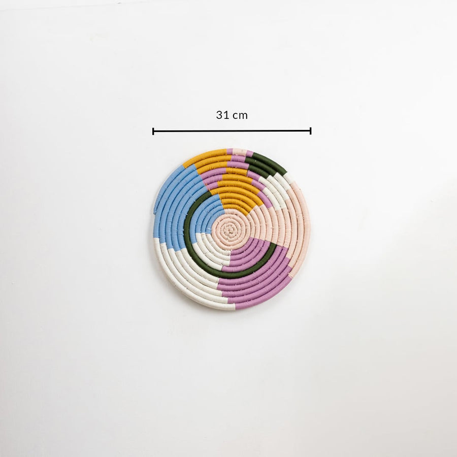 Cotton woven wall plate in pastel blue pink mustard green and cream shades shown on a white background with 31 cm measurement for accurate wall decor sizing.