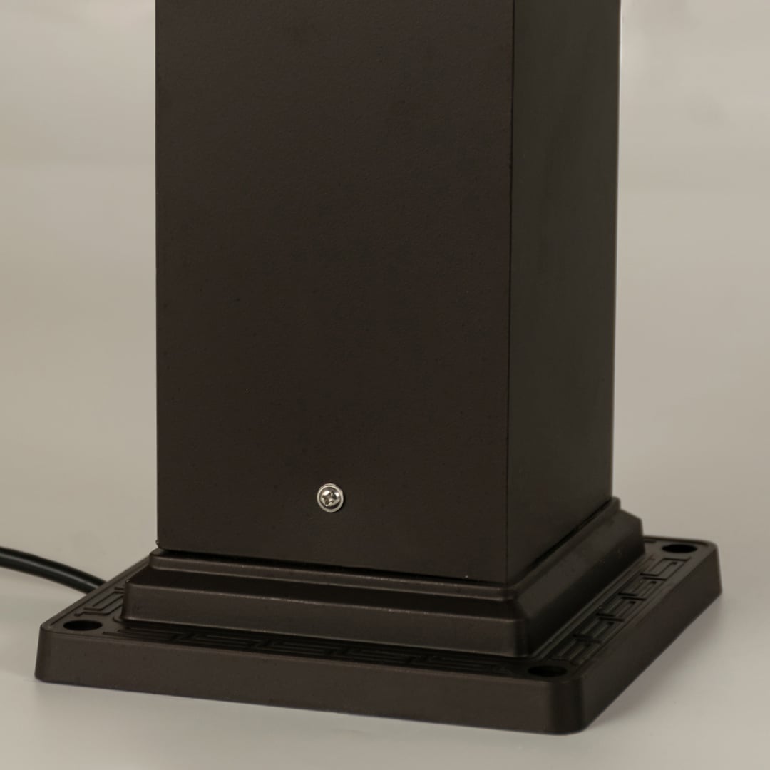 A closeup view of the outdoor bollard light highlighting the intricate geometric cutout design and frosted glass panel details that enhance its classic outdoor aesthetic.
