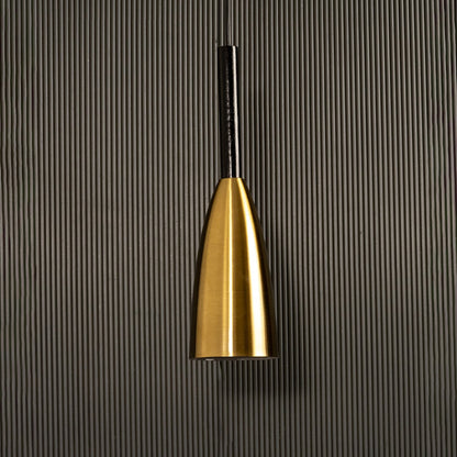A metal pendant light glowing softly against a ribbed dark backdrop creating elegant focused illumination and minimal refined décor.