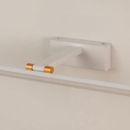 Closeup of white and gold metal picture light showing slim bar design smooth finish and warm directional illumination.