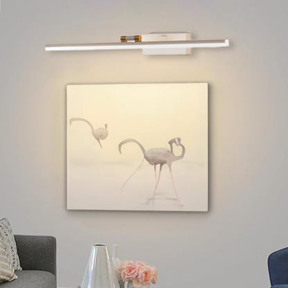 Lifestyle closeup of white and gold metal picture light enhancing artwork with warm focused gallery style illumination.