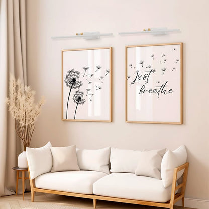 White and gold metal picture light styled on a modern interior wall adding soft focused illumination for elegant home decor.