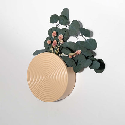 Modern beige round wall planter displayed in a minimal setting perfect for contemporary home styling and indoor decoration.