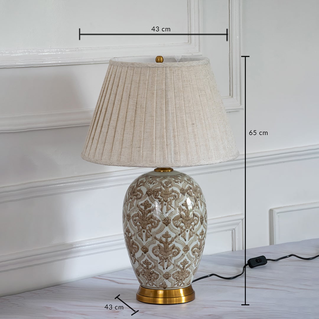 Ceramic table lamp with pleated shade and golden base showing 65 cm height and 43 cm width dimensions.