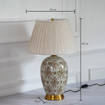 Ceramic table lamp with pleated shade and golden base showing 65 cm height and 43 cm width dimensions.
