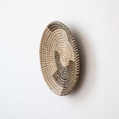 Side view of handwoven wicker basket wall decor showing woven depth and texture for rustic and boho home interiors.