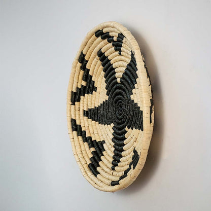 Side view of woven wall basket highlighting depth thickness and detailed craftsmanship of the handwoven material.
