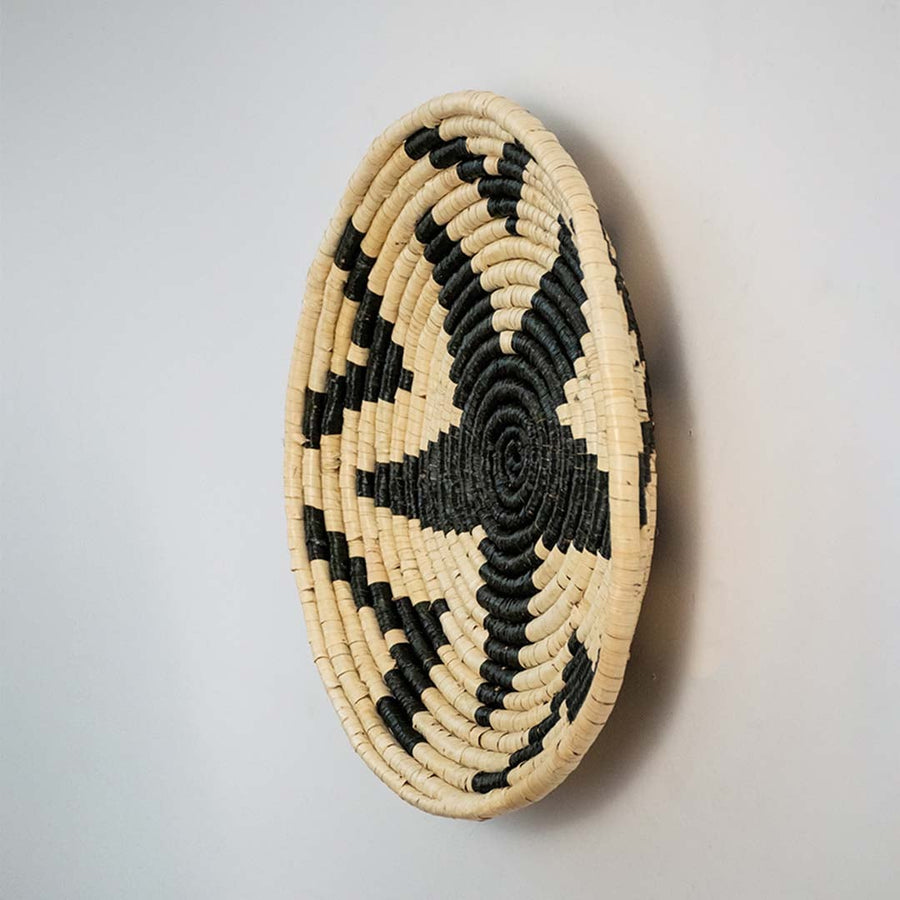 Side view of woven wall basket highlighting depth thickness and detailed craftsmanship of the handwoven material.