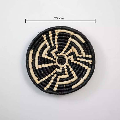 Round woven coaster with black and beige pattern on a white background, showing measurement label.