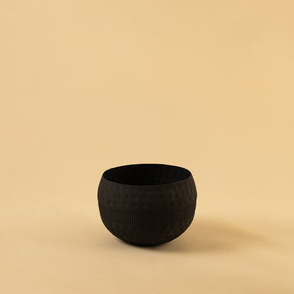 Black round textured planter bowl with matte interior photographed on a clean light background for a simple product display.