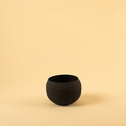 Black metal textured bowl decor on a clean white background showcasing its modern matte finish for versatile placement.