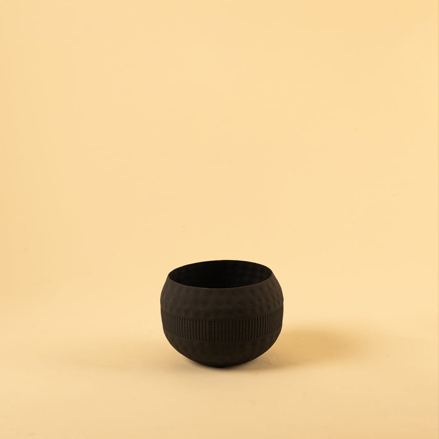 Black metal textured bowl decor on a clean white background showcasing its modern matte finish for versatile placement.