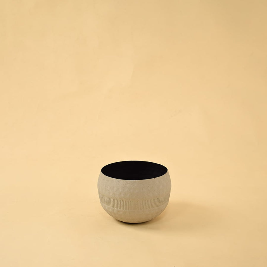 Cream round textured pot with matte black interior displayed on a clean white background for simple minimal home decor.