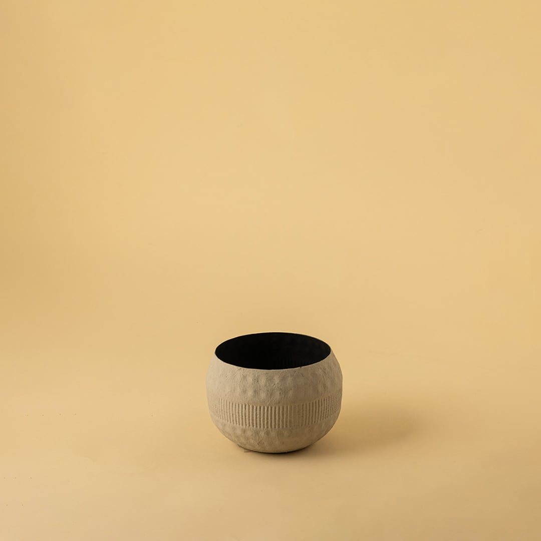 Small cream round textured pot with matte finish and black interior displayed on a clean white background for minimal home decor.