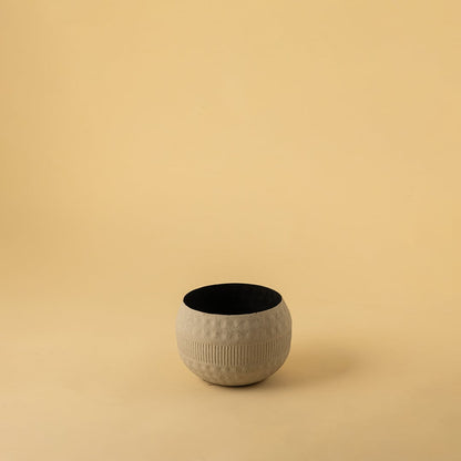 Small cream round textured pot with matte finish and black interior displayed on a clean white background for minimal home decor.