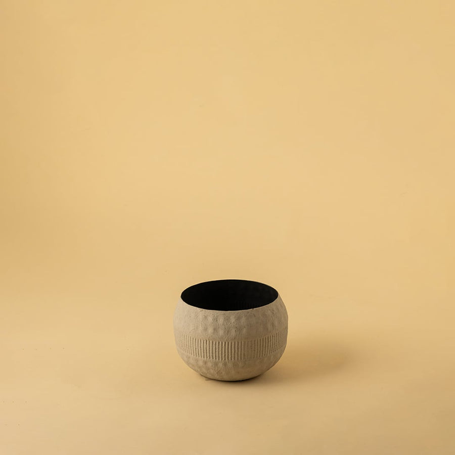 Small cream round textured pot with matte finish and black interior displayed on a clean white background for minimal home decor.
