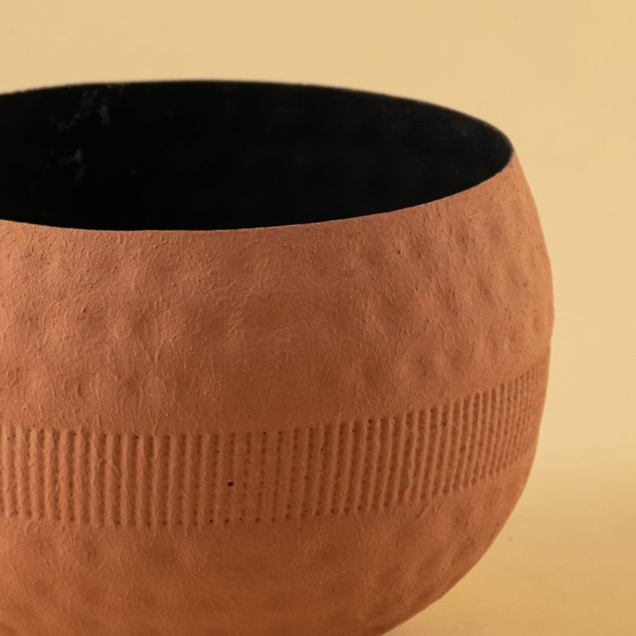 Detailed close view of the terracotta planter bowl highlighting its rounded form and fine textured design