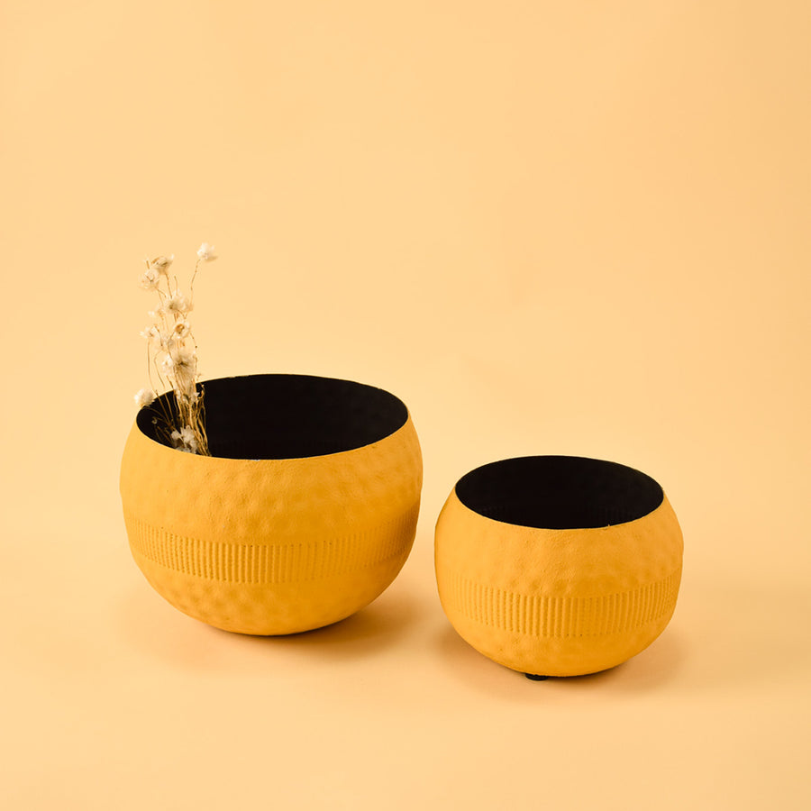Pair of vibrant textured yellow metal bowls for artistic modern home decor and creative tabletop centerpiece styling.