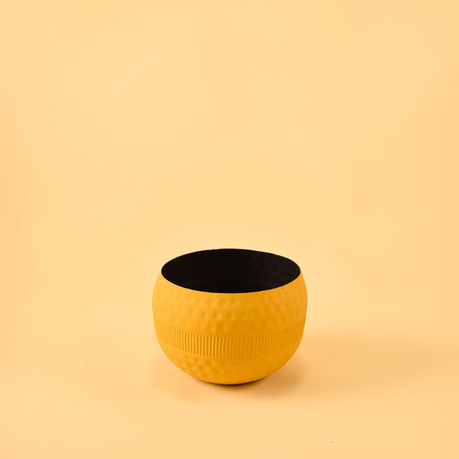 Yellow round textured pot with ribbed design and matte finish displayed on a clean white background for minimal modern decor.