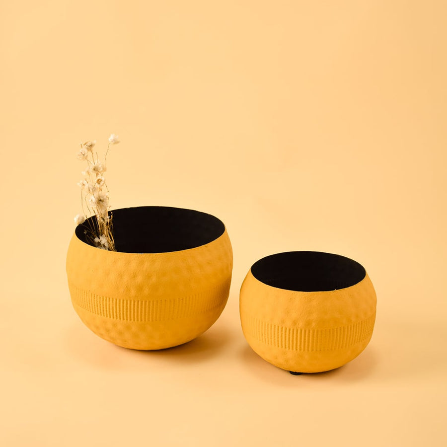 Yellow round decorative pot shown with matching decor pieces creating a modern coordinated display for living room styling.