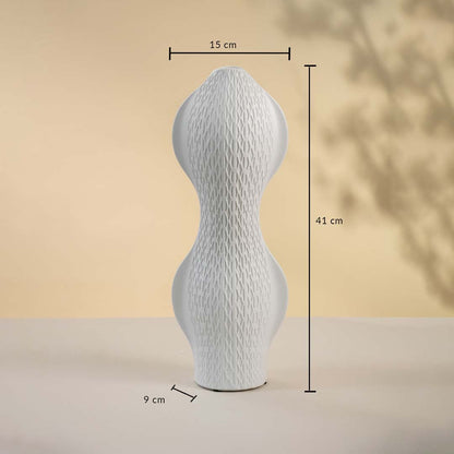 White geometric ceramic vase displayed on a neutral surface measuring 29 cm in height and 29 cm in width with 14 cm base width.