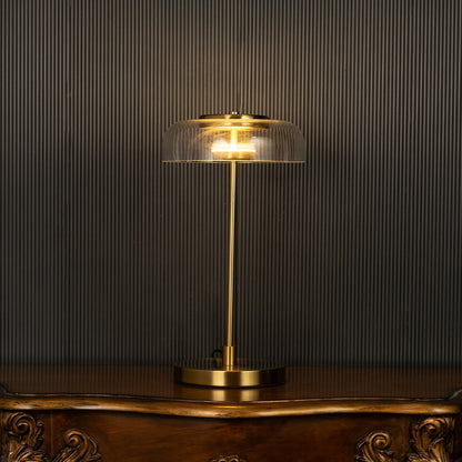 Gold and glass dome lamp with glowing shade shown on a black background creating a warm premium lighting effect for modern home decor.