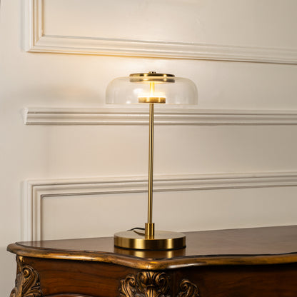 Gold metal table lamp with floating disc shade and cylindrical stem designed for elegant modern decorative lighting indoors.