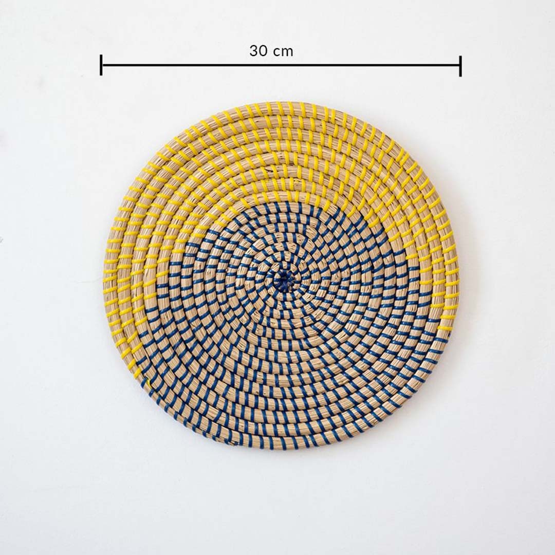 Round handcrafted wall basket in yellow blue and natural fiber showing 30 cm diameter suitable for modern wall decor use.