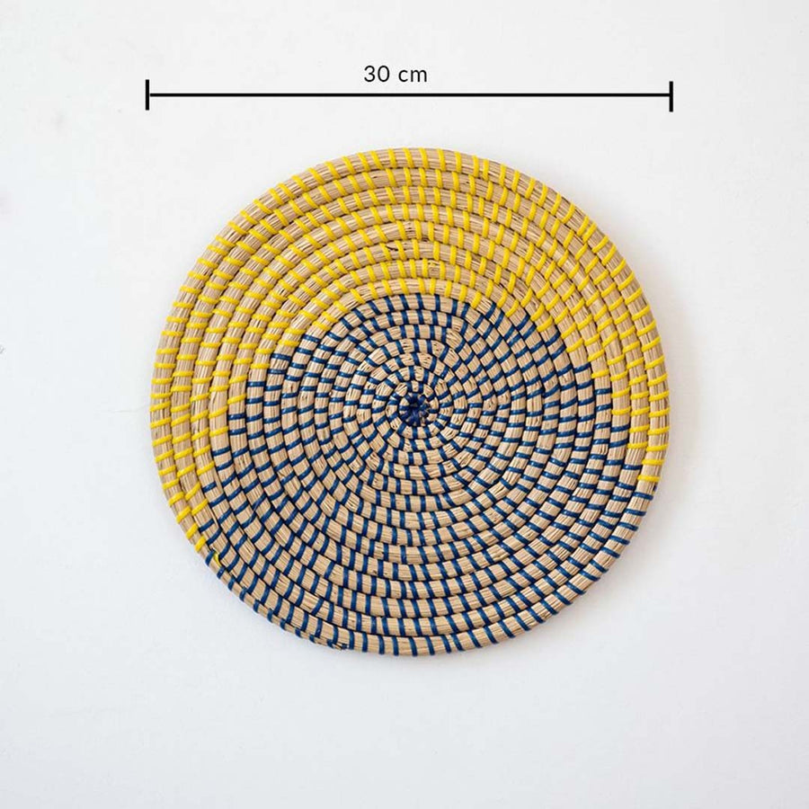 Round handcrafted wall basket in yellow blue and natural fiber showing 30 cm diameter suitable for modern wall decor use.
