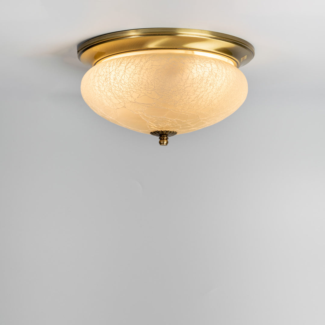 Modern antique brass ceiling light with textured frosted glass shade for elegant bedroom and hallway decor spaces.