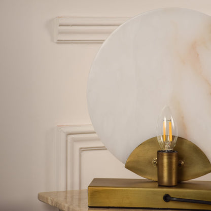 Closeup of marble table lamp showcasing natural stone texture and brass craftsmanship reflecting high-end design and durability.