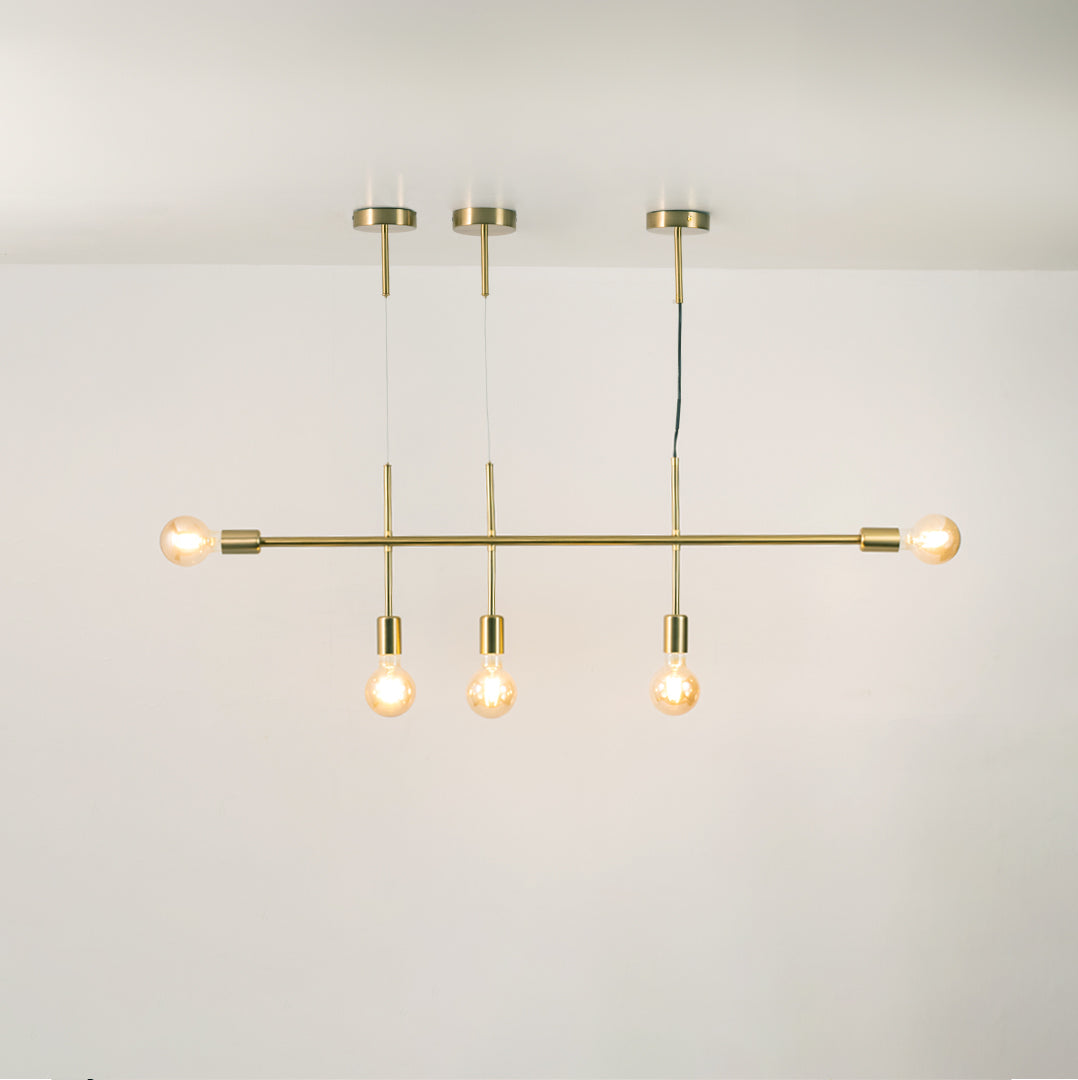 Gold metal chandelier with illuminated globe shades and pendant spotlights creating warm modern ambient lighting.