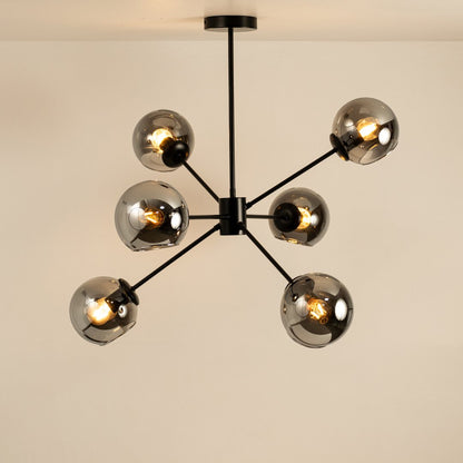 Black and gold metal chandelier with illuminated exposed bulbs creating warm ambient lighting for stylish interiors.