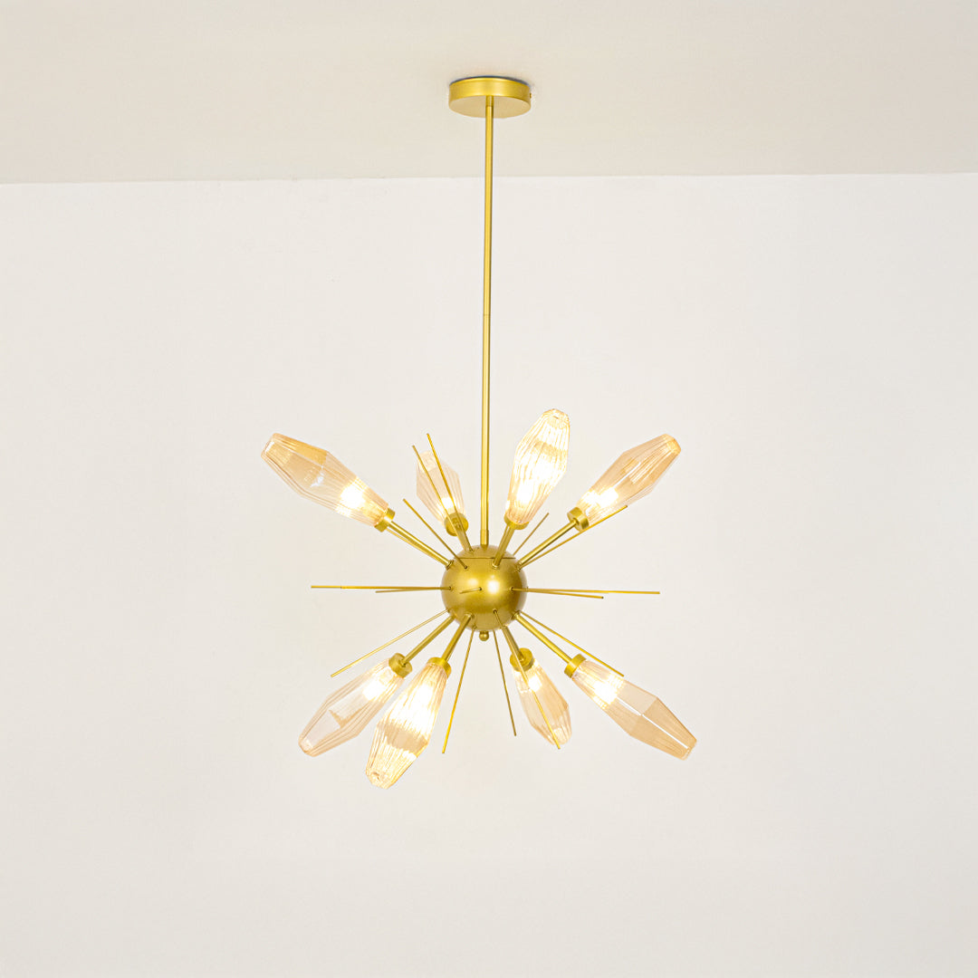 Gold metal starburst chandelier with illuminated crystal accents offering sophisticated contemporary ceiling lighting indoors.