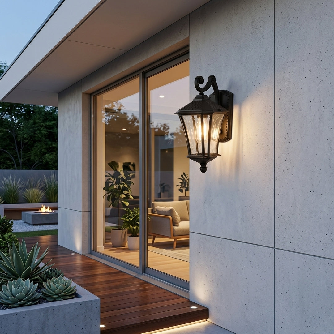 Black metal outdoor wall light lifestyle image with clear paneled glass shade mounted on a modern concrete patio wall.