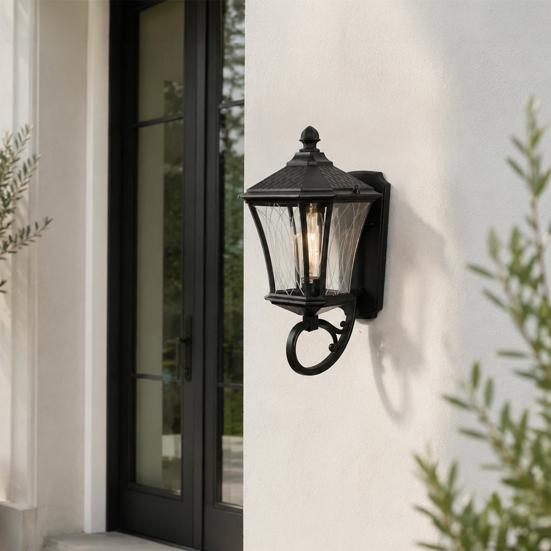 Black metal outdoor lantern wall light lifestyle image on modern exterior wall for elegant patio decor.