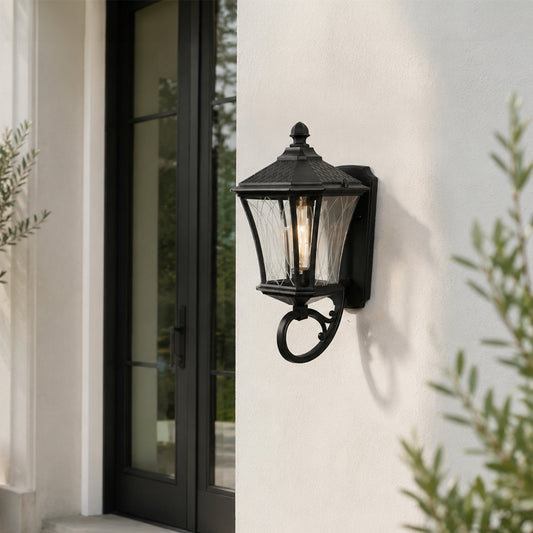 Black metal outdoor lantern wall light lifestyle image on modern exterior wall for elegant patio decor.
