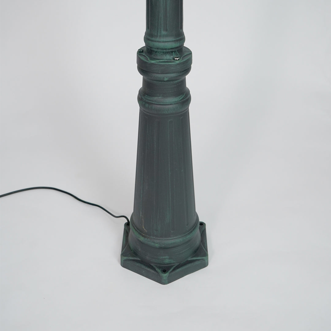 Closeup of black outdoor street lamp pole with ornate metal detailing for luxury exterior decor use.