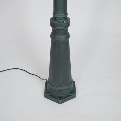 Closeup of black outdoor street lamp pole with ornate metal detailing for luxury exterior decor use.