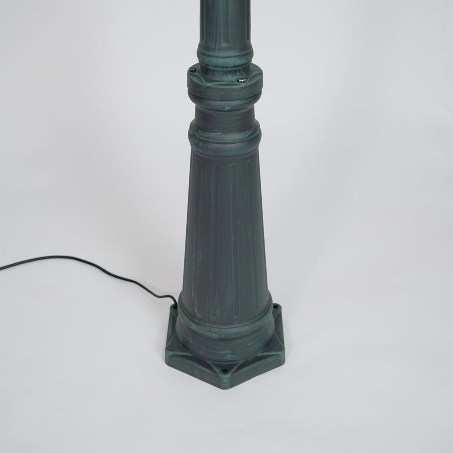 Closeup of black outdoor street lamp pole with ornate metal detailing for luxury exterior decor use.