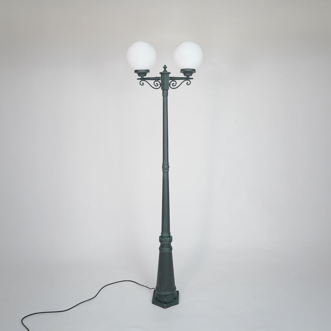 Vintage outdoor street lamp with glowing dual globe lights for elegant exterior decor styling use.