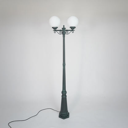 Vintage outdoor street lamp with glowing dual globe lights for elegant exterior decor styling use.