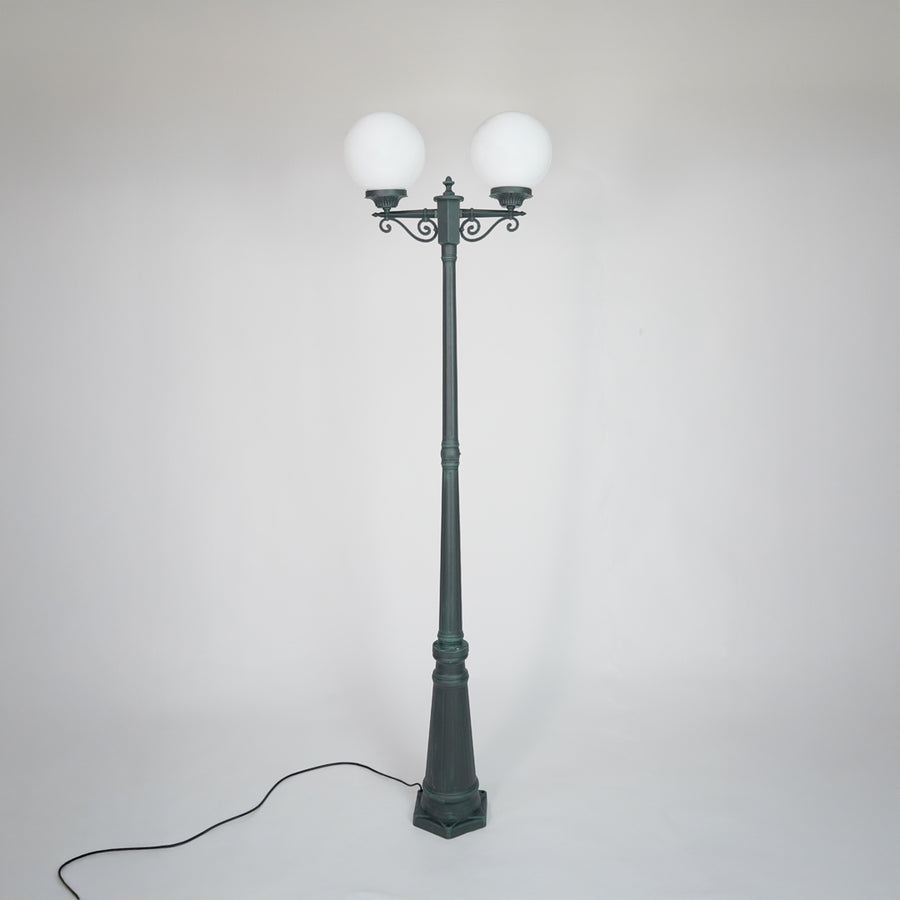 Vintage outdoor street lamp with glowing dual globe lights for elegant exterior decor styling use.