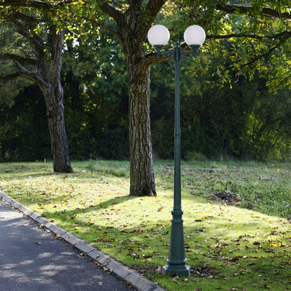 Vintage outdoor street lamp styled beside pathway and trees for elegant garden decor ambiance.