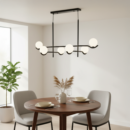 Black metal chandelier with frosted glass globe shades illuminating dining area with contemporary ambient lighting style.