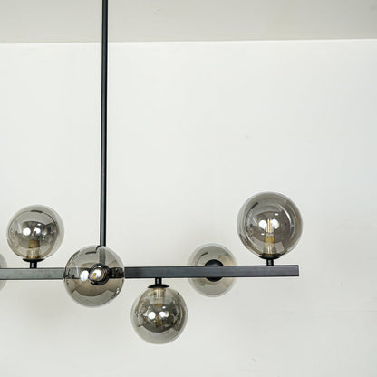 Smoked glass globe chandelier with black metal frame showcasing elegant craftsmanship and contemporary decorative lighting.
