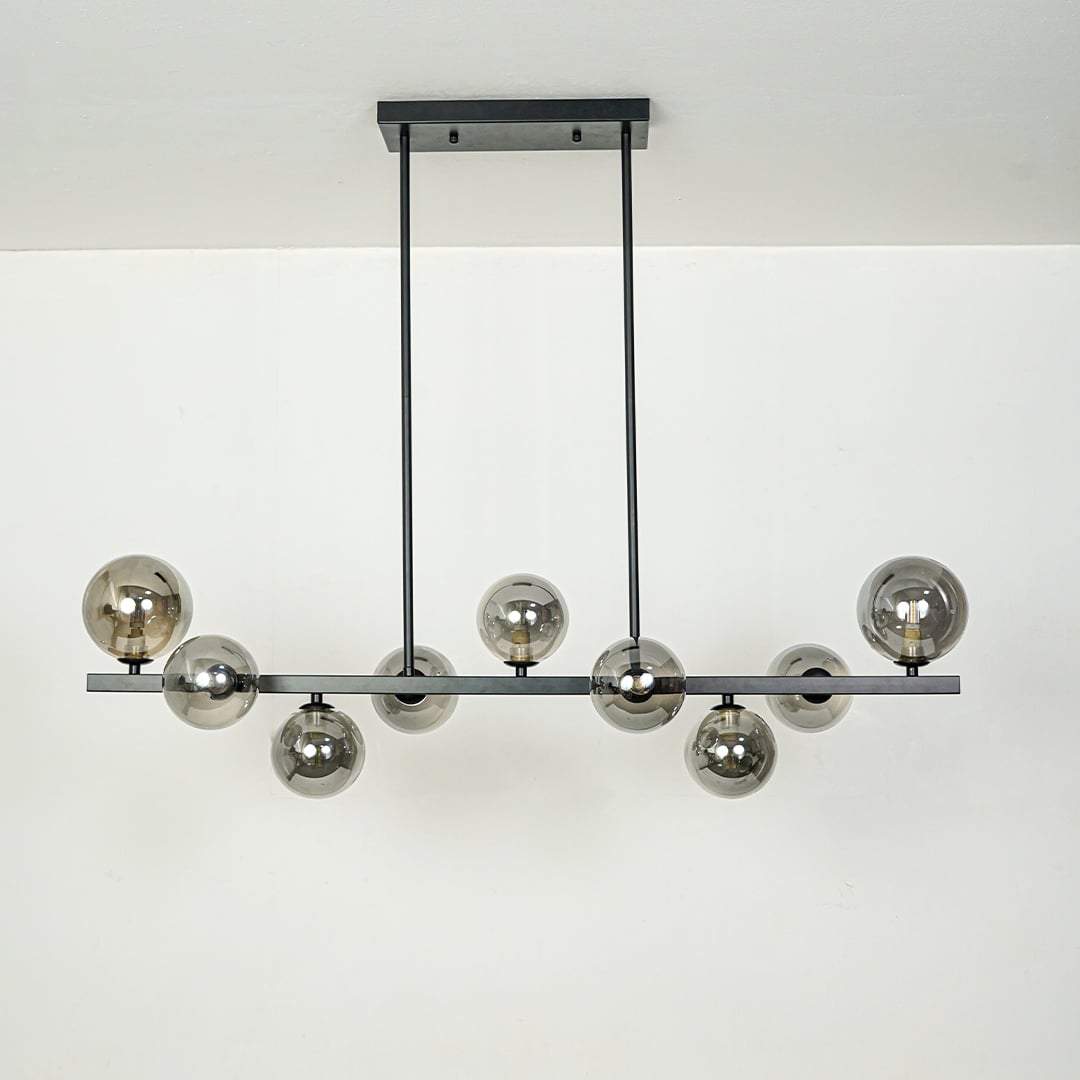 Smoked glass globe chandelier with black metal frame designed for elegant modern ceiling lighting in contemporary homes.