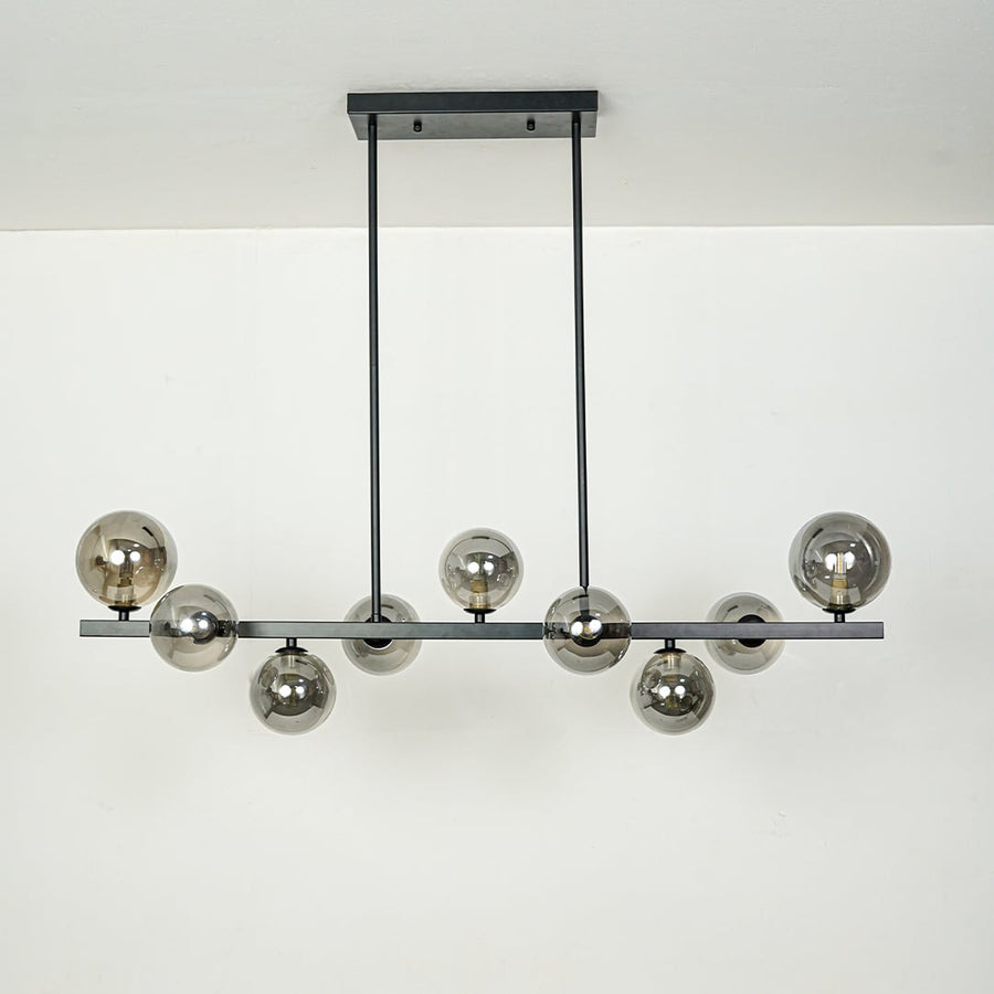 Smoked glass globe chandelier with black metal frame designed for elegant modern ceiling lighting in contemporary homes.